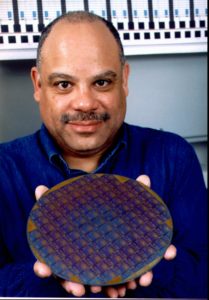 Dr. Mark E. Dean, director of IBM's Austin Research Laboratory in Austin, Texas, displays a wafer containing 1000 MHz microprocessors, in this undated photo. The laboratory announced the technological breakthrough Wednesday, Feb. 4, 1998, in San Francisco. (AP Photo/IBM)