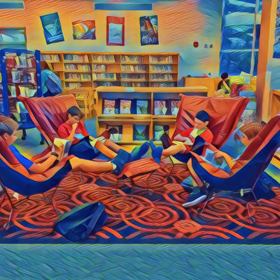 students reading in comfy chairs in library