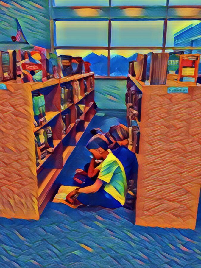 students reading in the library stacks