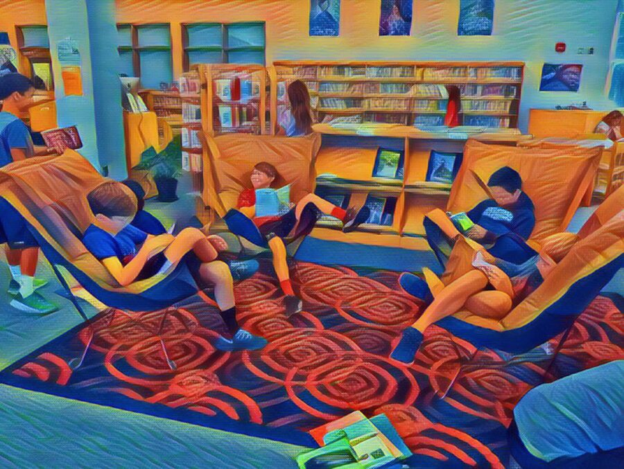 students reading in comfy chairs