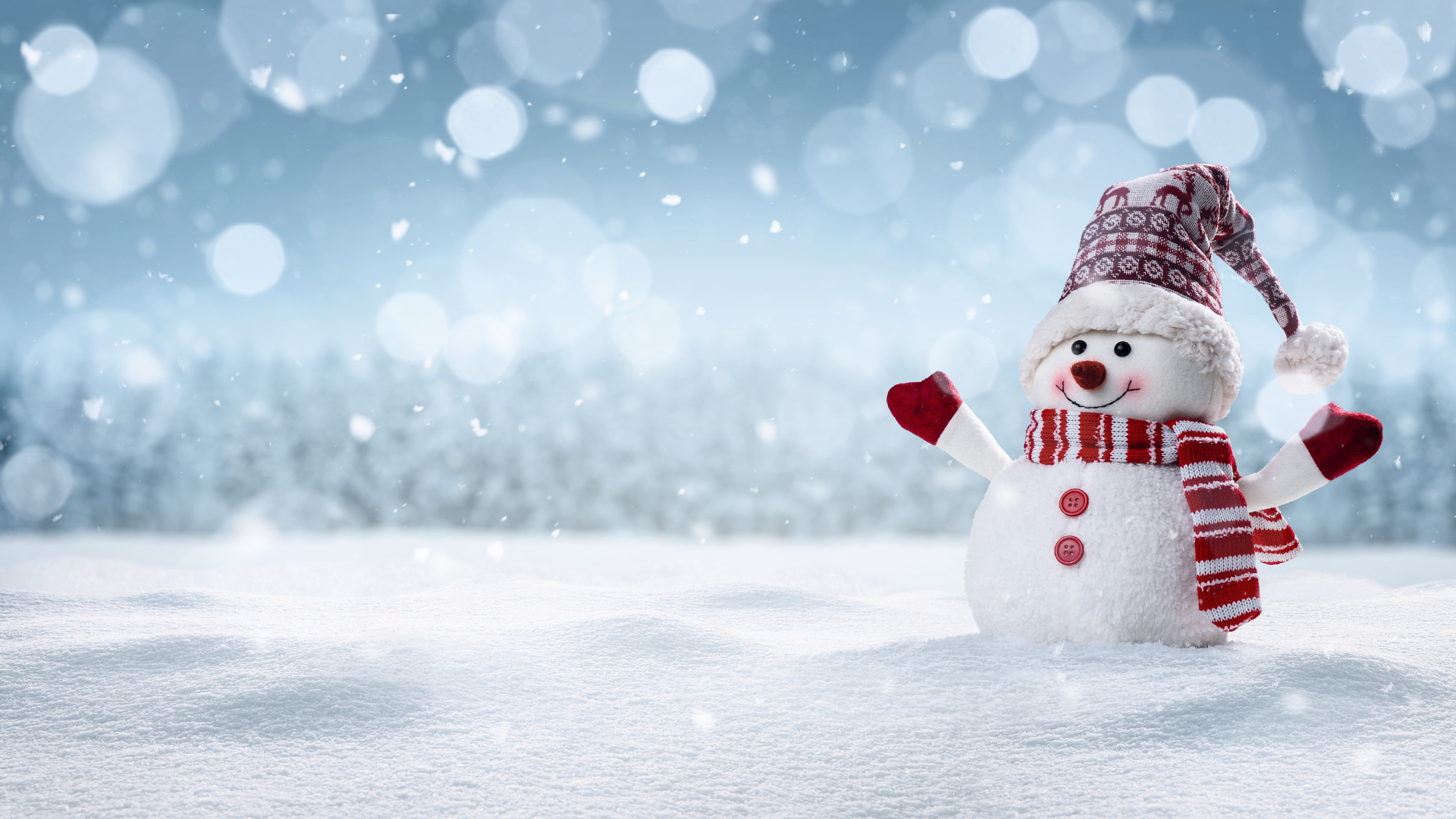 photo of snowman with snow falling