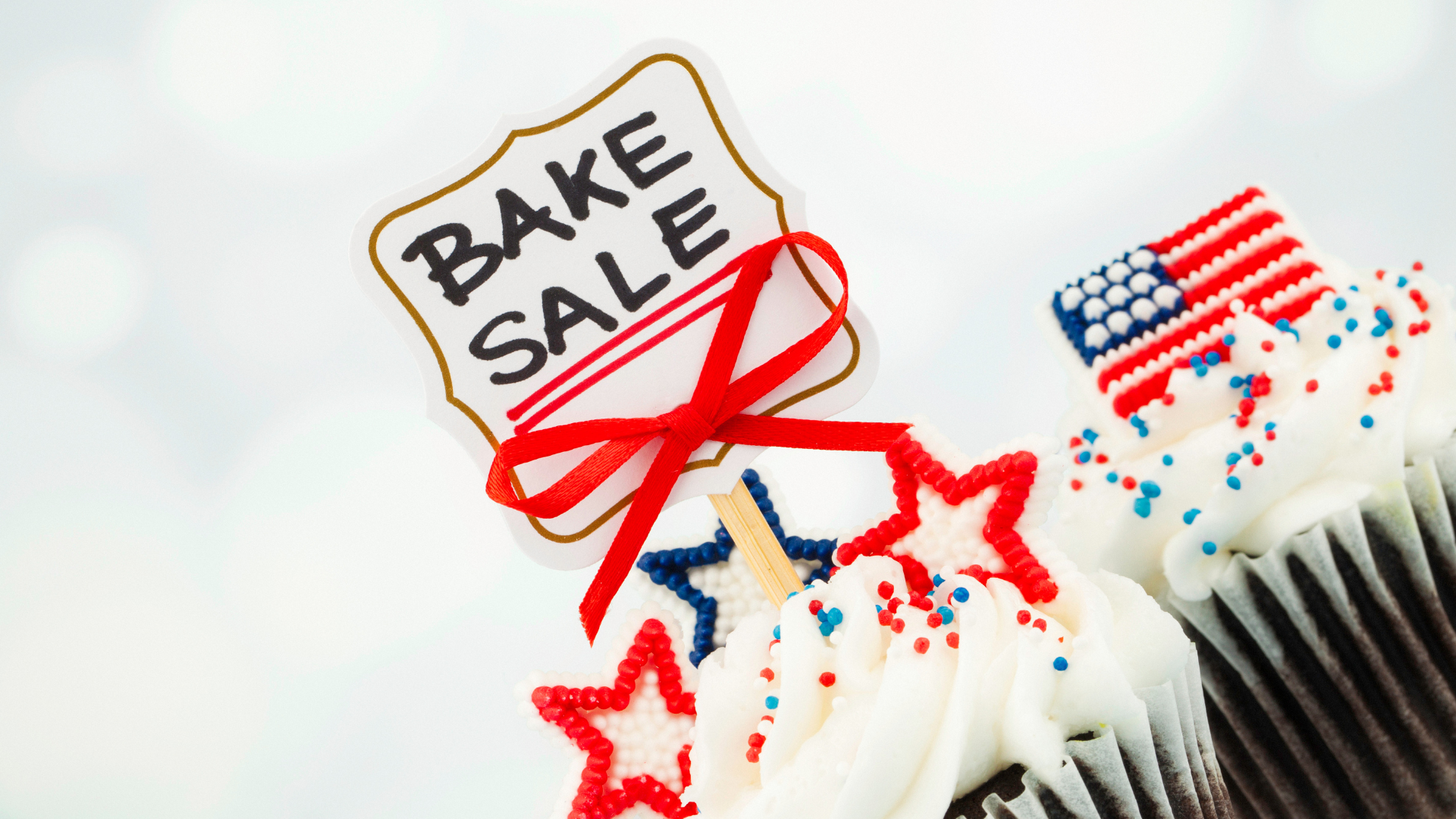 image of cupcake decorated w/ a bake sale sign