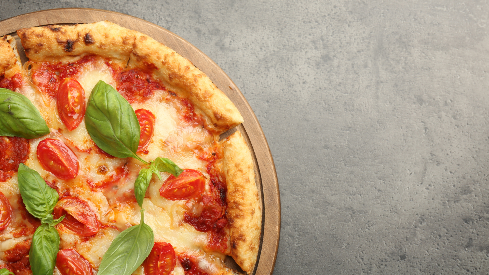 image of a pizza pie on a stone gray background