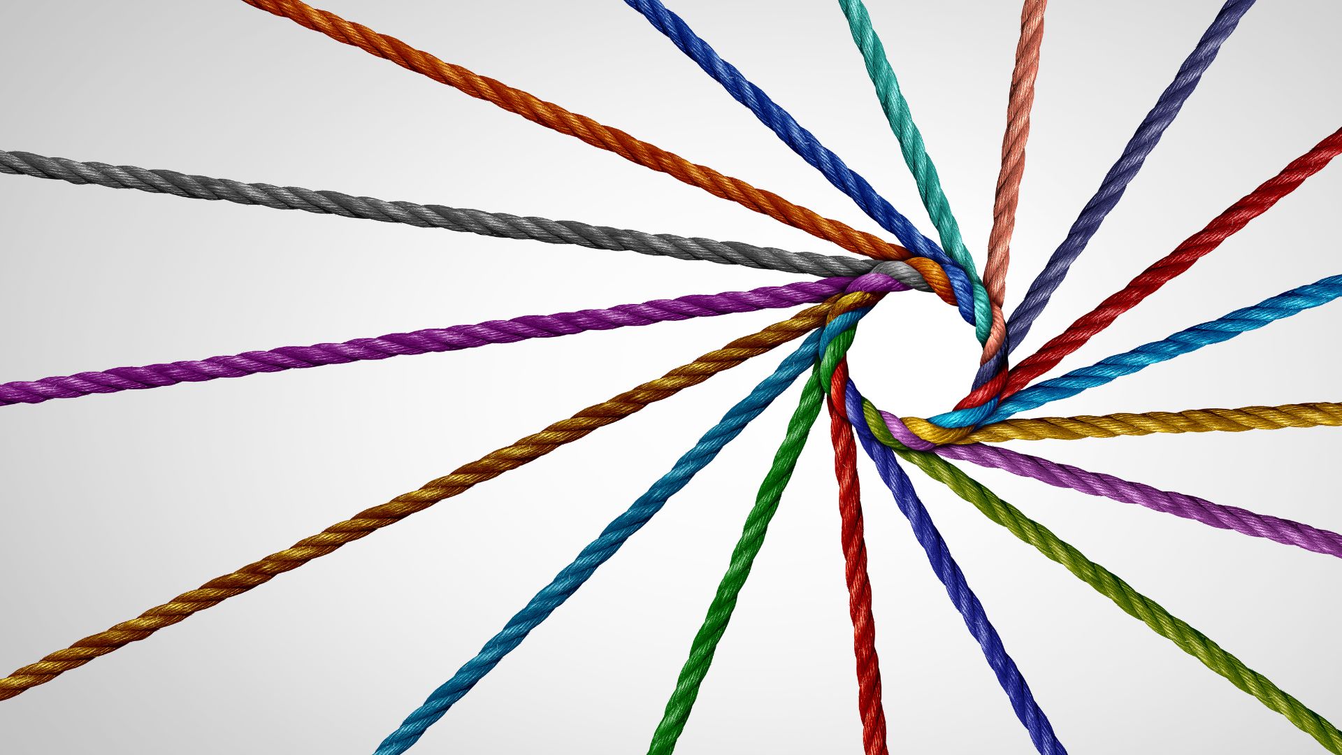 different colored thread joining together to create a multicolored rope